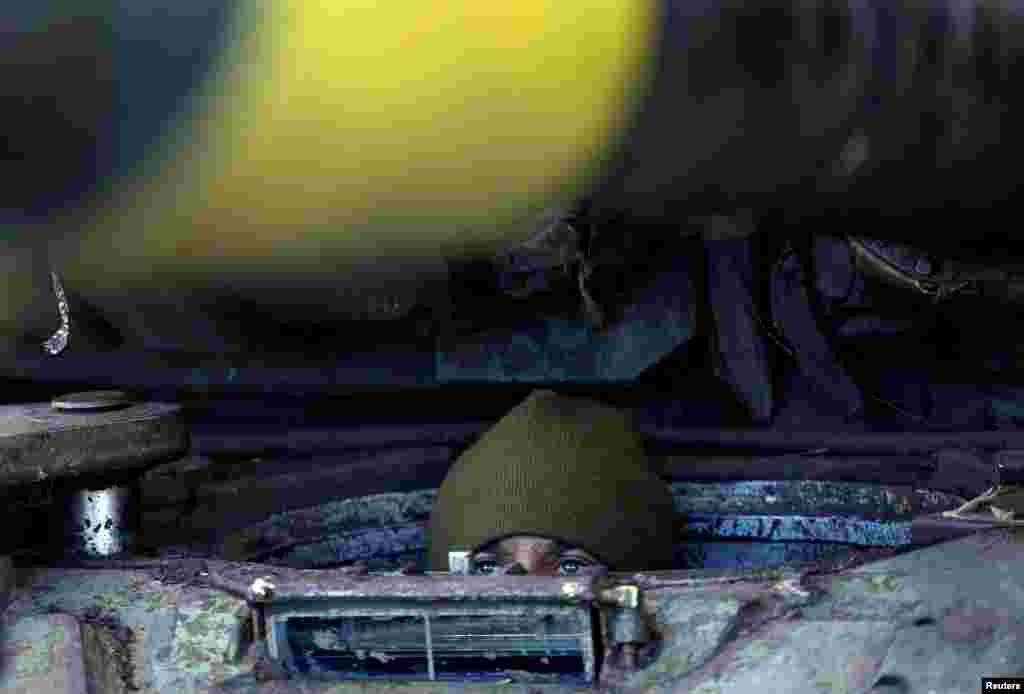 A Ukrainian serviceman of the 1st Independent Tank Brigade looks out from a D-64 tank as Russia's attack on Ukraine continues, near the frontline of Vuhledar, in Donetsk region.