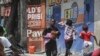 FILE - Residents flee their homes to escape clashes between armed gangs in Port-au-Prince, Haiti, on Aug. 15, 2023.