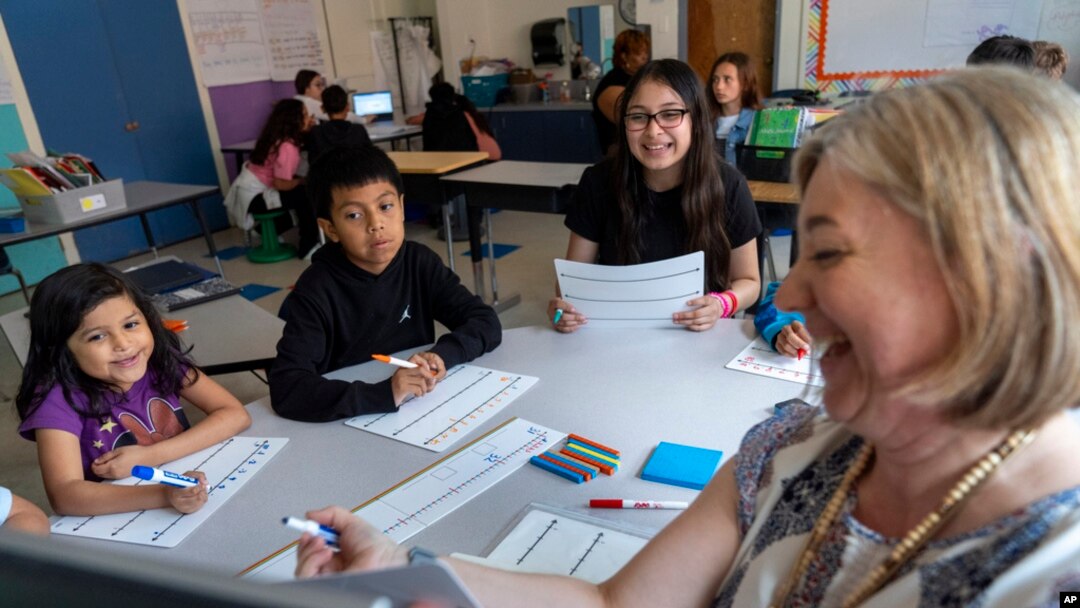 Fifth grade students attend a math lesson with teacher Jana Lamontagne, right, during class at Mount Vernon Community School, in Alexandria, Va., May 1, 2024. 