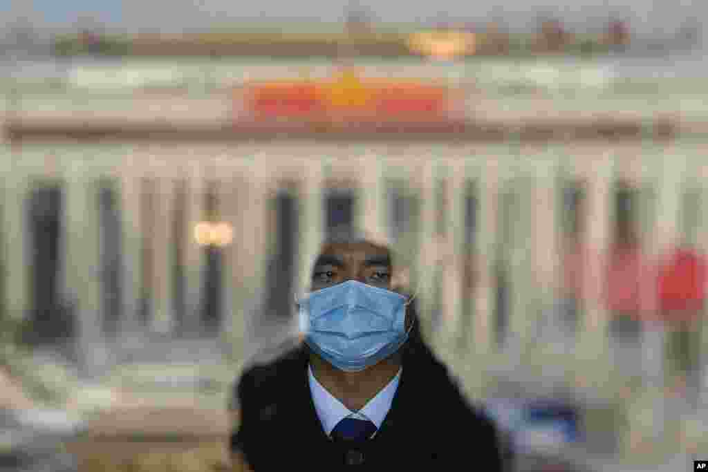 A soldier dressed as an usher stands guard at an entrance door of the Great Hall of the People in Beijing.