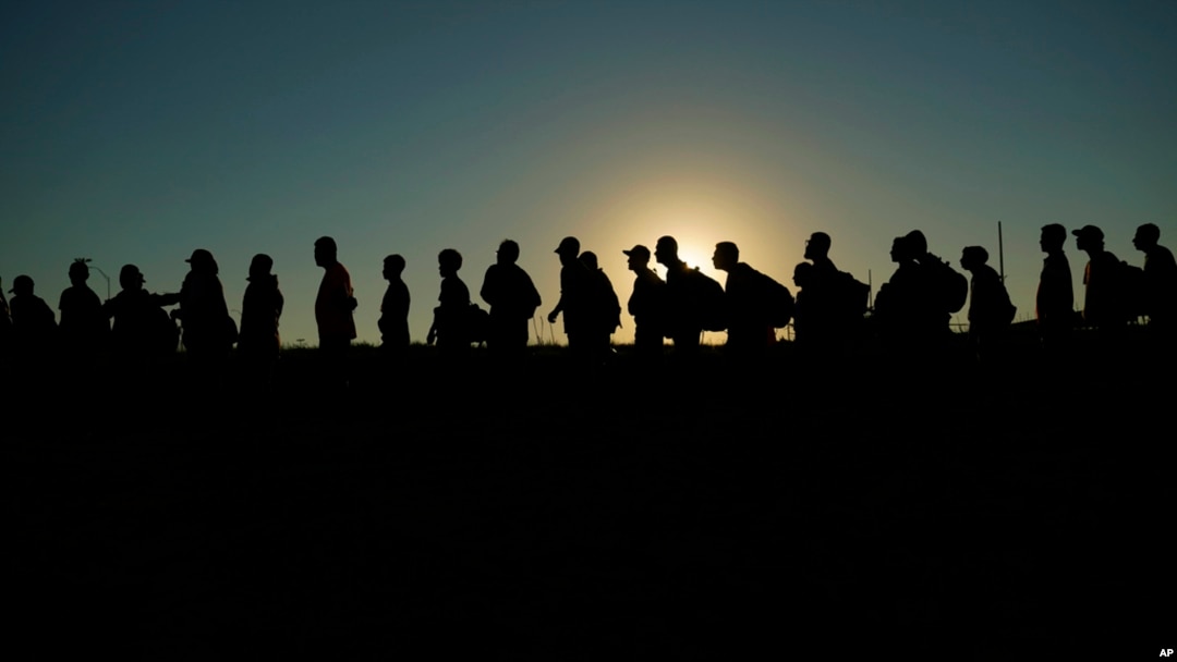 FILE - Migrants who entered the U.S. from Mexico line up for processing, Sept. 23, 2023, in Eagle Pass, Texas. A judge on March 8, 2024, upheld a Biden administration policy that allows a limited number of migrants from four countries to enter the U.S. on humanitarian grounds.
