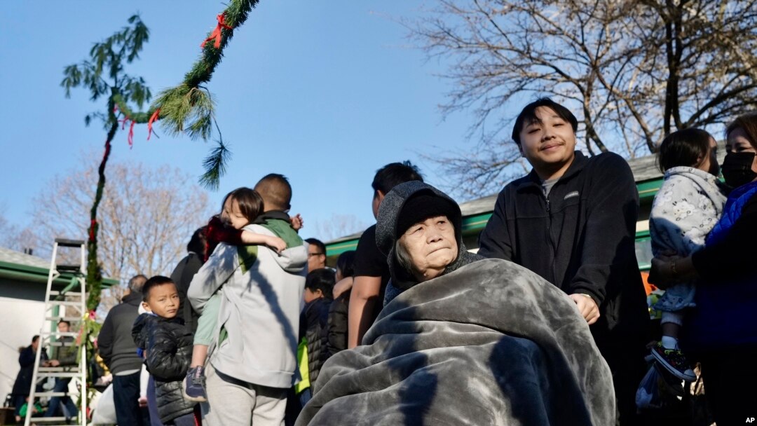 The Twin Cities Hmong community gather for a Hmong New Year sweeping ritual in St. Paul, Minnesota, Nov. 18, 2023. The ritual, in which participants walk together in circles, represents leaving old negative spirits behind and embracing the new year.