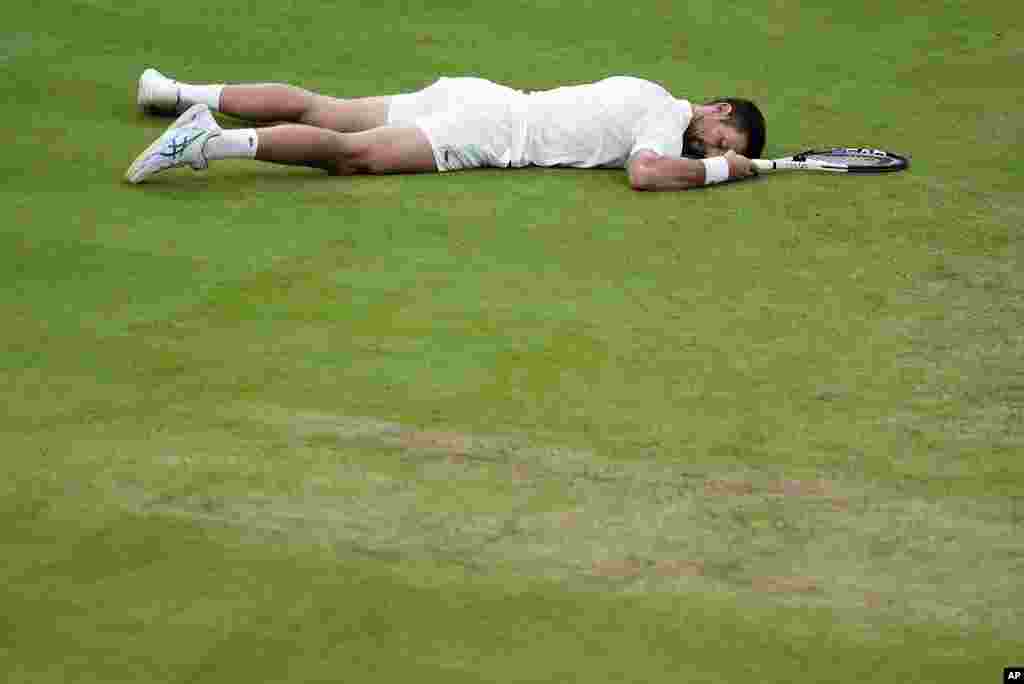 Serbia's Novak Djokovic lays on the court after slipping against Italy's Jannik Sinner in a men's singles semifinal match on day 12 of the Wimbledon tennis championships in London. Djokovic went on to win the match.