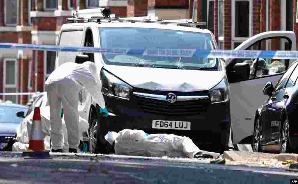 Forensics officers work at the scene of a "major incident" in which three people were found dead on Bentinck Road in Nottingham, England. Police arrested a suspect in the deaths and who they say might be involved in trying to run over three other people in Nottingham.