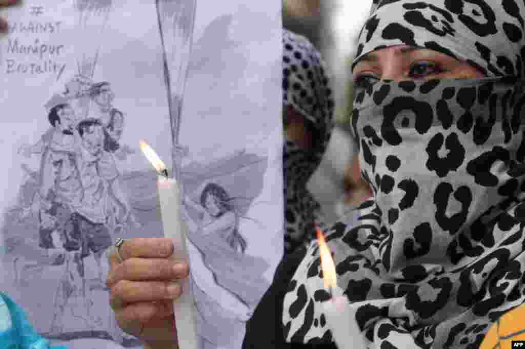 Congress workers take part in a candlelight vigil over sexual violence against women in the ongoing ethnic violence in India's north-eastern state of Manipur, in Amritsar. Indian police have arrested four men accused of parading two women naked in front of a mob in a northeastern state where months of ethnic violence have left at least 120 dead. 