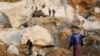 FILE - Workers move pieces of extracted marble from a marble mine in Sagyin, Mandalay, Myanmar, Feb. 15, 2019.