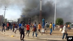 Anti-government demonstrators set a barricade on fire during clashes in N'Djamena, Chad, Oct. 20, 2022.