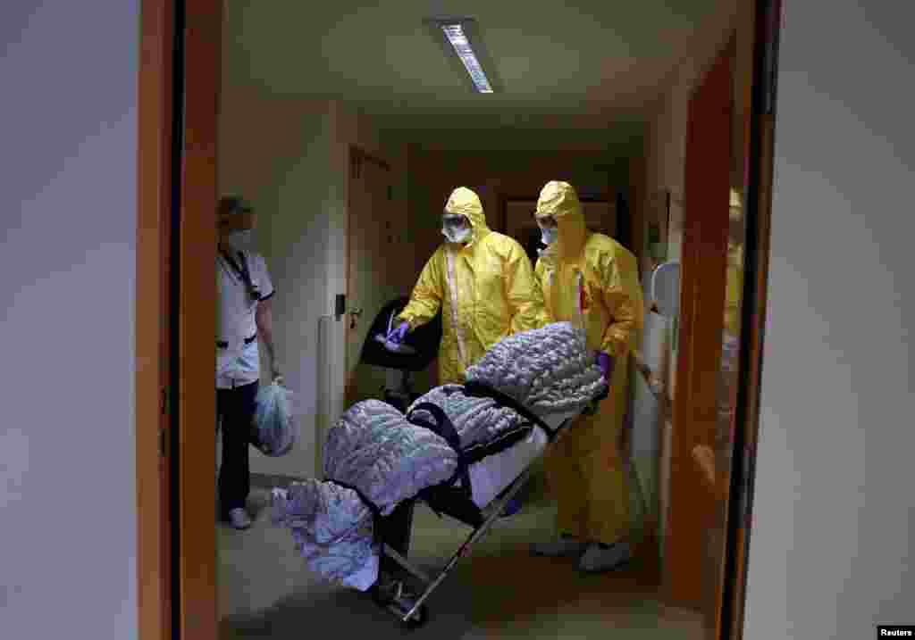 Mortuary employees transport the body of a person in an elderly residence following the coronavirus disease (COVID-19) outbreak in Brussels, Belgium.