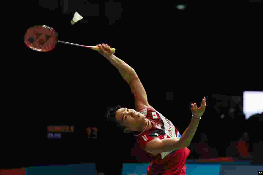 Japan's Kento Momota hits a return shot against China's Huang Yu Xiang during Malaysia Master men's single badminton quarterfinal in Kuala Lumpur, Malaysia.