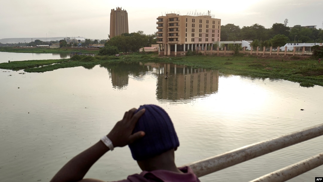 FILE - A boy looks at the city of Bamako from the Martyrs Bridge, on May 25, 2021. 