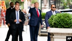 Former President Donald Trump gestures as he departs Trump Tower, Wednesday, Aug. 10, 2022, in New York, on his way to the New York attorney general's office for a deposition in a civil investigation.