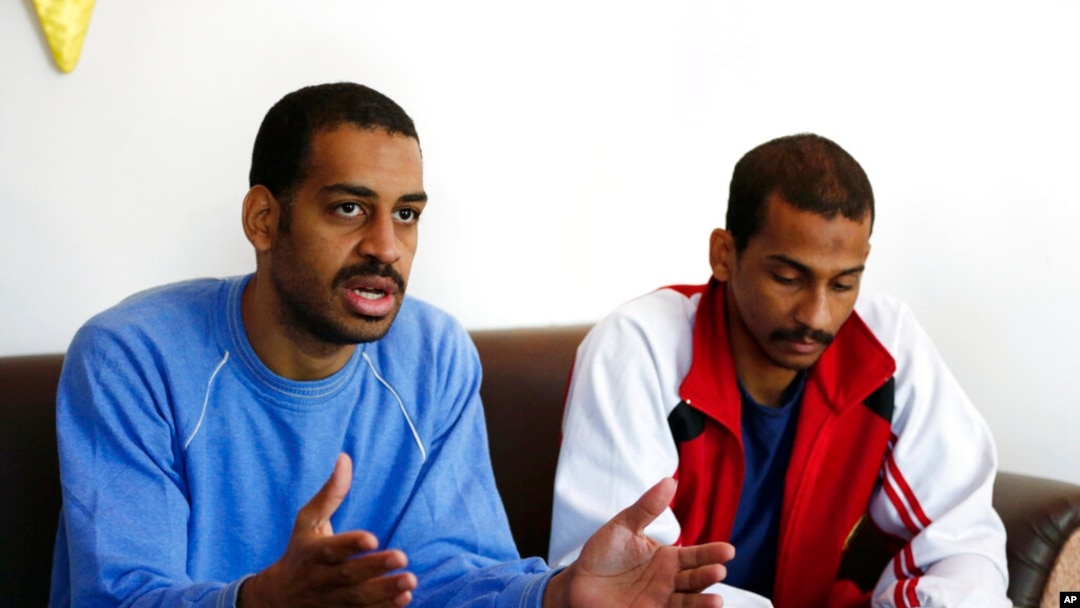 FILE - In this March 30, 2018, photo, Alexanda Amon Kotey, left, and El Shafee Elsheikh, who were allegedly among four British jihadis who made up a brutal Islamic State cell dubbed 'The Beatles,' speak in Kobani, Syria. 
