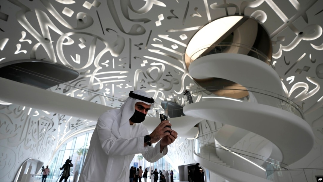 A man take a photo at the Museum of the Future, an exhibition space for innovative and futuristic ideas in Dubai, United Arab Emirates, Wednesday, Feb. 23, 2022. (AP Photo/Kamran Jebreili)
