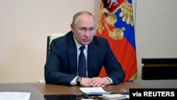 FILE - Russian President Vladimir Putin chairs a meeting with members of the Security Council via a video link at the Novo-Ogaryovo state residence outside Moscow, Russia March 3, 2022.