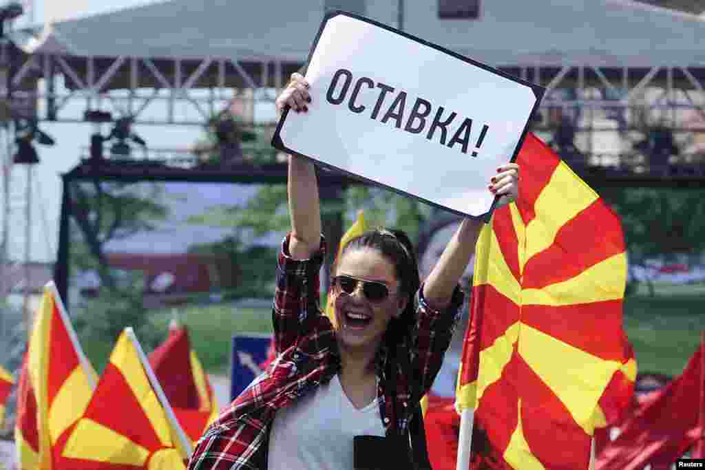 A woman raises a sign reading "resignation" during an anti-government demonstration in Skopje, Macedonia, May 17, 2015.