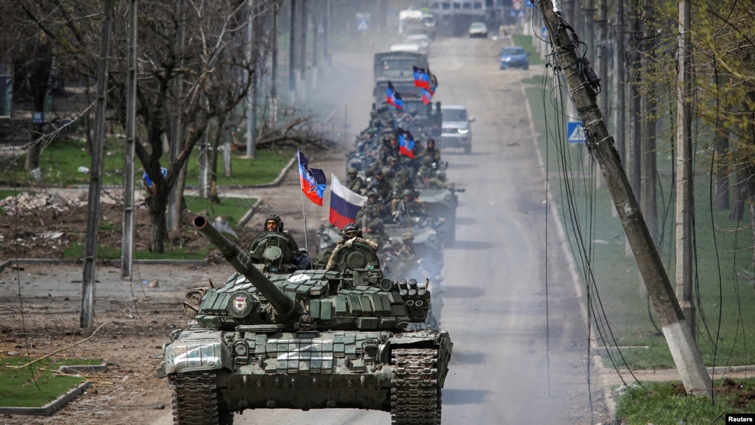 An armored convoy of pro-Russian troops moves along a road during Ukraine-Russia conflict in the southern port city of Mariupol, Ukraine April 21, 2022. 