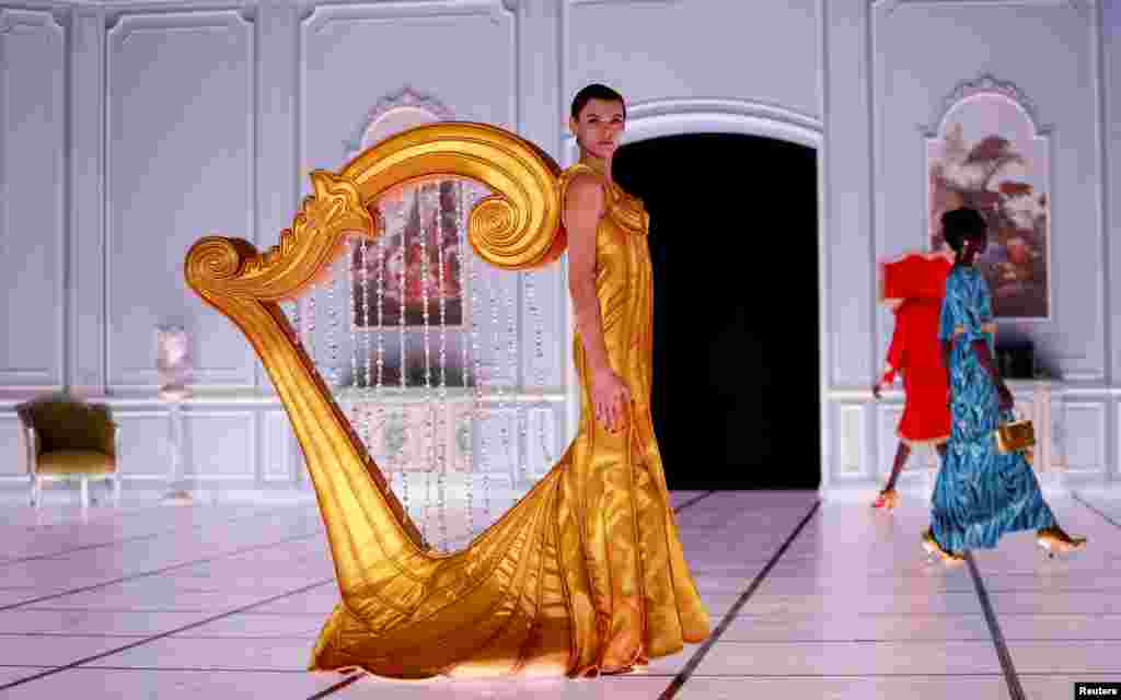 A model presents a creation from the Moschino Fall-Winter 2022/2023 collection during Fashion Week in Milan, Italy, Feb. 24, 2022.