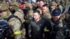 Ukrainian President Volodymyr Zelenskyy walks on Kherson's central square during his visit on Monday, November 14, 2022. (Ukrainian Presidential Press Office via AP)