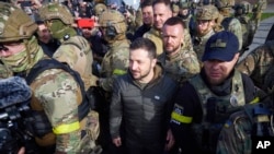 Ukrainian President Volodymyr Zelenskyy walks on Kherson's central square during his visit on Monday, November 14, 2022. (Ukrainian Presidential Press Office via AP)