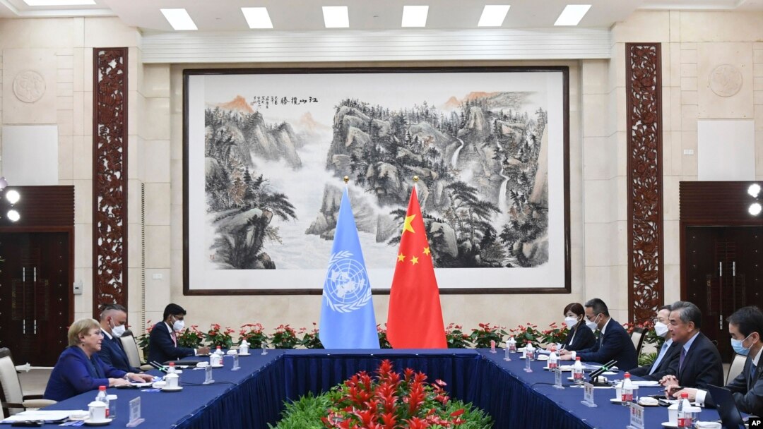 FILE - In this photo released by Xinhua News Agency, Chinese Foreign Minister Wang Yi, second right, meets with U.N. High Commissioner for Human Rights Michelle Bachelet, left, in Guangzhou, Guangdong province, China, May 23, 2022.