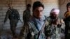 Kurdish fighters from the People's Protection Units (YPG) stand in a house in Raqqa, Syria, June 21, 2017. 