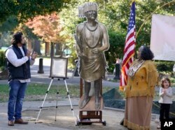 Jesse Tarango, left, chairman of Wilton Rancheria, and his mother, Mary Tarango, look at an enlarged photo of a statue of the late William Franklin Sr. during a groundbreaking ceremony for a Native American monument at Capitol Park in Sacramento, Calif.