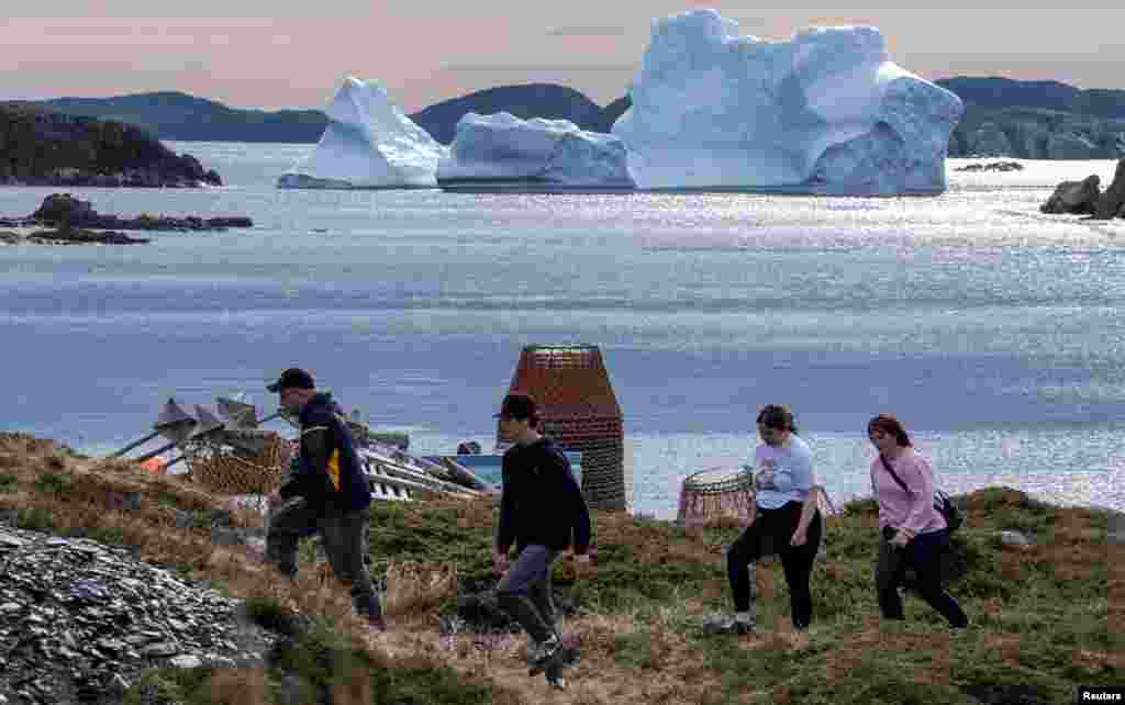Visitors come to see a large iceberg drifting off the coast of Merritt's Harbor, Newfoundland, Canada, May 22, 2022.