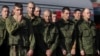 Russian recruits stand waiting to take a train at a railway station in Prudboi, Volgograd, region of Russia, September 29, 2022. 