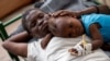 Karina Joseph, 19, comforts her 2-year-old child Holanda Sineus as she receives treatment for cholera in a tent at a Doctors Without Borders hospital in Cite Soleil, a densely populated commune of Port-au-Prince, Haiti, Oct. 15, 2022. 