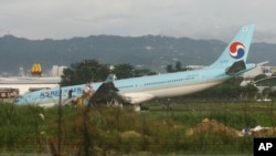 A damaged Korean Air plane lies after it overshot the runway at the Mactan-Cebu International Airport in Cebu, central Philippines early Oct. 24, 2022. The Korean Air plane overshot the runway while landing in bad weather in the central Philippines