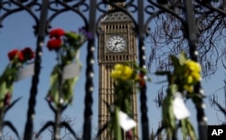 Floral tributes to the victims of the Westminster terrorist attack are placed outside the Palace of Westminster, London, March 27, 2017. Attacker Khalid Masood is believed to have used the messaging service WhatsApp before running down pedestrians on Westminster Bridge and stabbing to death a policeman.