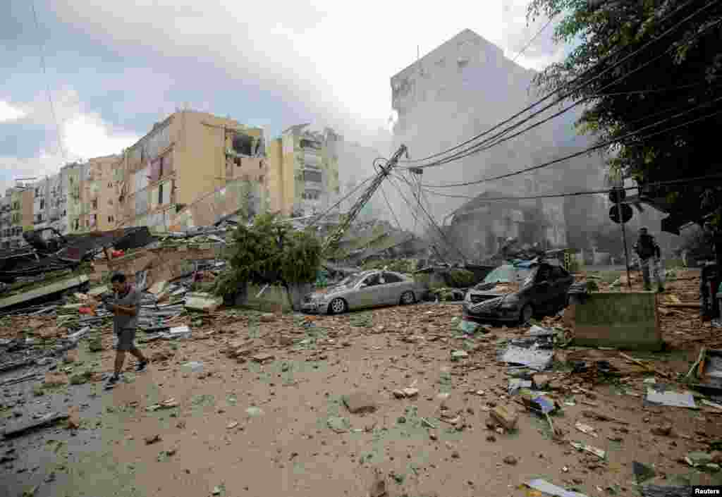 A man walks near damaged buildings in the aftermath of Israeli strikes on Beirut's southern suburbs, Lebanon.