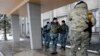 Ukrainian soldiers stand outside the city council building in the town of Debaltseve, Ukraine, Jan. 31, 2015. 