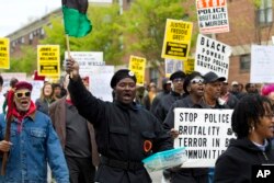 FILE - Demonstrators protest in the streets as they march for Freddie Gray to Baltimore's City Hall, in Baltimore, April 25, 2015.