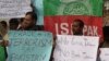 FILE - People protest against an Islamic State-claimed attack on a shrine earlier this year, in Peshawar, Pakistan, Feb. 17, 2017.