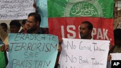 FILE - People protest against an Islamic State-claimed attack on a shrine earlier this year, in Peshawar, Pakistan, Feb. 17, 2017.