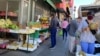 FILE - People wear masks as they shop in the Chinatown neighborhood of San Francisco, California, July 31, 2020.