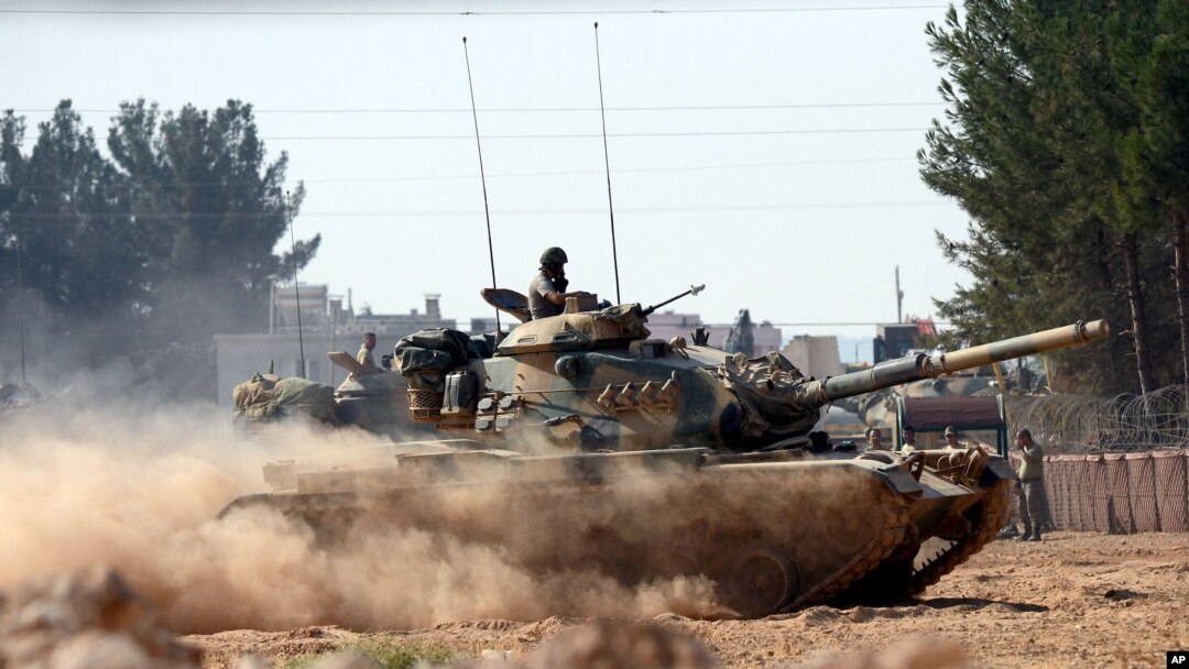 Turkish tanks head towards the Syrian border, in Karkamis, Turkey, Aug. 31, 2016. 
