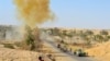 FILE - Iraqi army soldiers clear the roads of roadside bombs after defeating Islamic State extremists from villages outside Ramadi, west of Baghdad, Oct. 10, 2016.