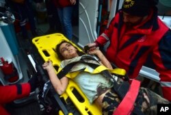 A rescuer takes care of a young girl rescued four days after an earthquake, in Kahramanmaras, southern Turkey, Feb. 10, 2023.