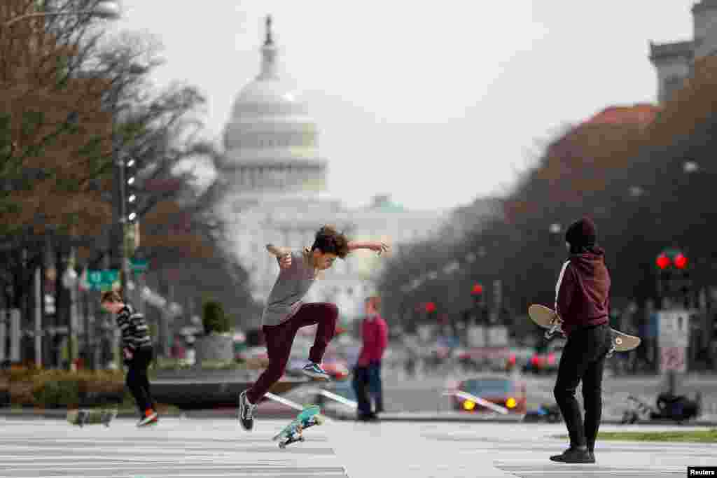 Kids perform skateboard tricks at Freedom Plaza as Mayor Muriel Bowser declared a State of Emergency due to the coronavirus outbreak (COVID-19) in Washington, March 16, 2020.
