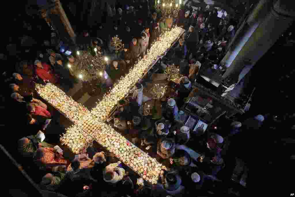 Worshipers gather around candles during Mass for the 'sanctification of honey' at the Presentation of the Blessed Virgin church in the town of Blagoevgrad, some 100 km (62 miles) south of the Bulgarian capital.