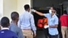 A worker checks the temperature of travelers at the border post with Kenya in Namanga, northern Tanzania, on March 16, 2020.