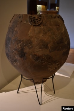 A Neolithic jar, possibly a Neolithic qvevri used for brewing wine from the site of Khramis Didi Gora south of Tbilisi on display at the Georgian National Museum is seen in this handout photo received Nov. 13, 2017.