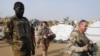 FILE - Soldiers of the Barkhane Force and the Malian army patrol in a market of Menaka, in the region of Liptako, Mali, March 21, 2019