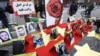 Pictures of people who died during anti-government demonstrations in Iran are displayed as Iranian community members and their supporters take part in a protest in solidarity with the Iranian people, in Paris, France, Feb. 12, 2023.