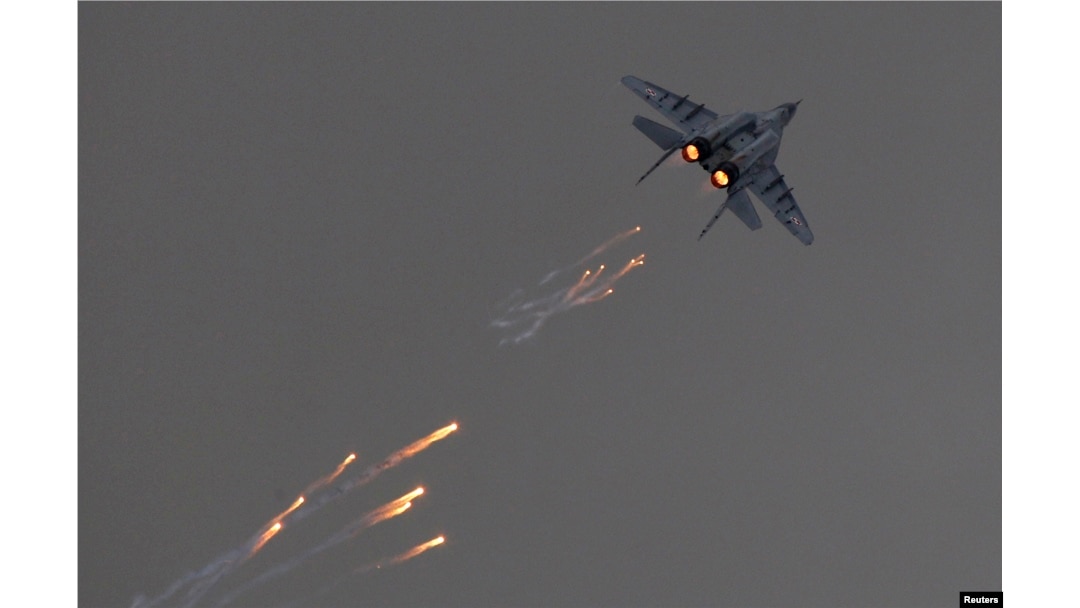 FILE - A Polish Air Force MiG-29 jet fires flares during a demonstration flight at the Radom Air Show, at Radom airport, Poland, Aug. 24, 2013.