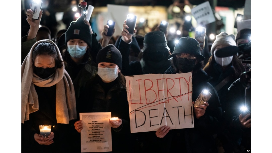 FILE - Protesters gather near the Chinese consulate to stand in solidarity with their counterparts around the world demonstrating against China's severe anti-virus restrictions, in New York, Nov. 29, 2022.