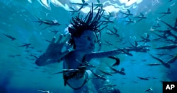 This image released by 20th Century Studios shows Trinity Bliss, as Tuk, in a scene from "Avatar: The Way of Water."