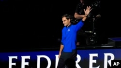 Team Europe's Roger Federer of Switzerland, waves during the opening ceremony of the Laver Cup tennis tournament at the O2 in London, Sept. 23, 2022.